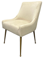 Como chair in beige with curved seat, wingback back, and brass-toned legs