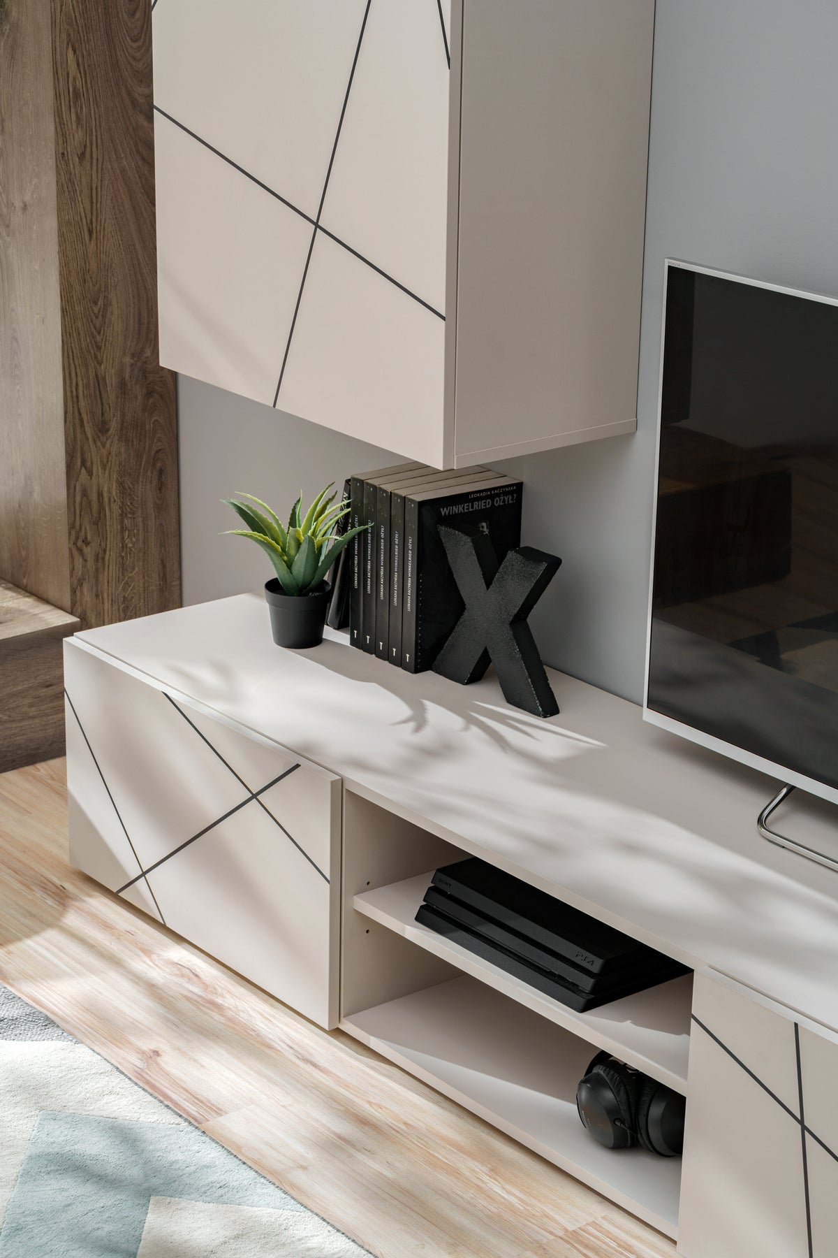 White media wall unit with open shelves and diagonal stripe door panels
