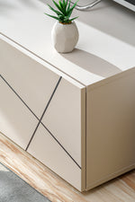 White side cabinet with black diagonal line panels and recessed edge detail