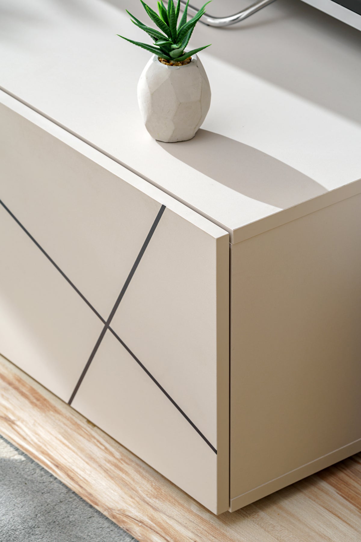 White side cabinet with black diagonal line panels and recessed edge detail