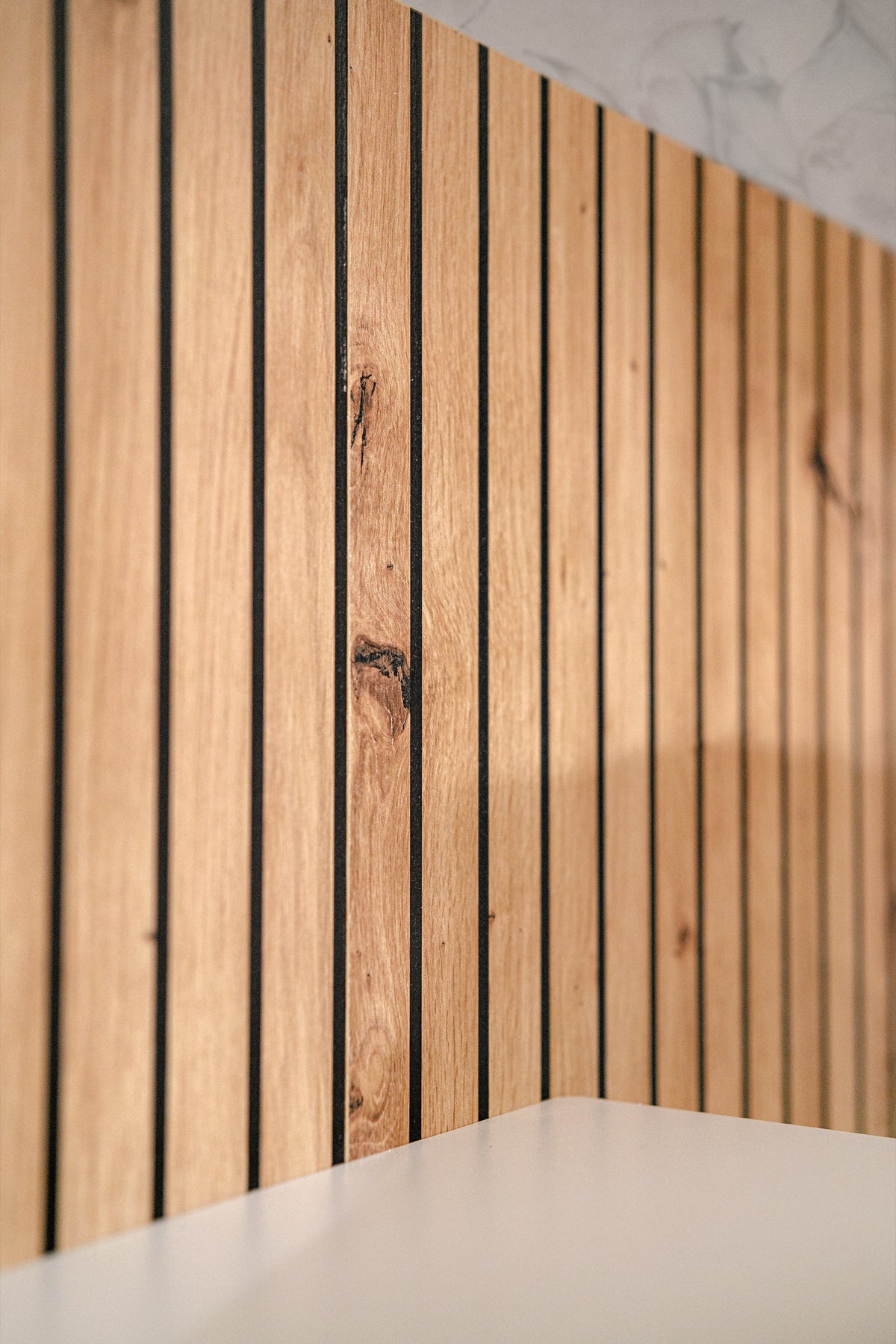 Close-up of vertical wood slat panel with visible grain and texture