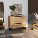 Light wood chest of drawers with three drawers and dark legs.