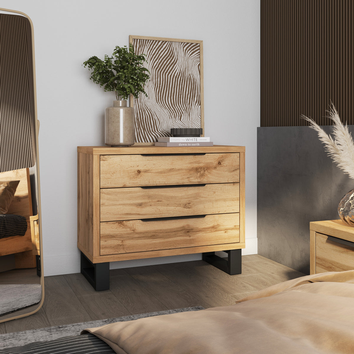 Light wood chest of drawers with three drawers and dark legs.