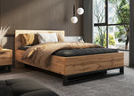 Wood-look ottoman bed with black frame, beige and dark gray bedding set