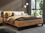 Wood-look ottoman bed with black frame, beige quilt and dark gray mattress