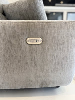 Grey electric recliner sofa corner button control on armrest