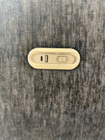 Grey sofa upholstery with electric control buttons panel