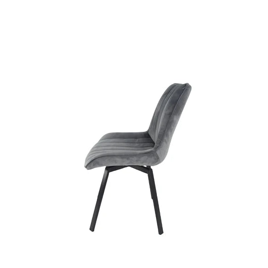 Grey velvet upholstered chair with tall curved back and black tapered legs