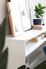 White desk with built-in side storage compartments and hinged top