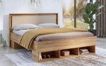 Wooden bed frame with drawers, bed linens and storage drawers visible