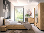 Wood bedside table with open shelf and drawer beside bed in bedroom