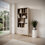 Light beige bookcase with open shelves and ribbed lower doors in a bright room