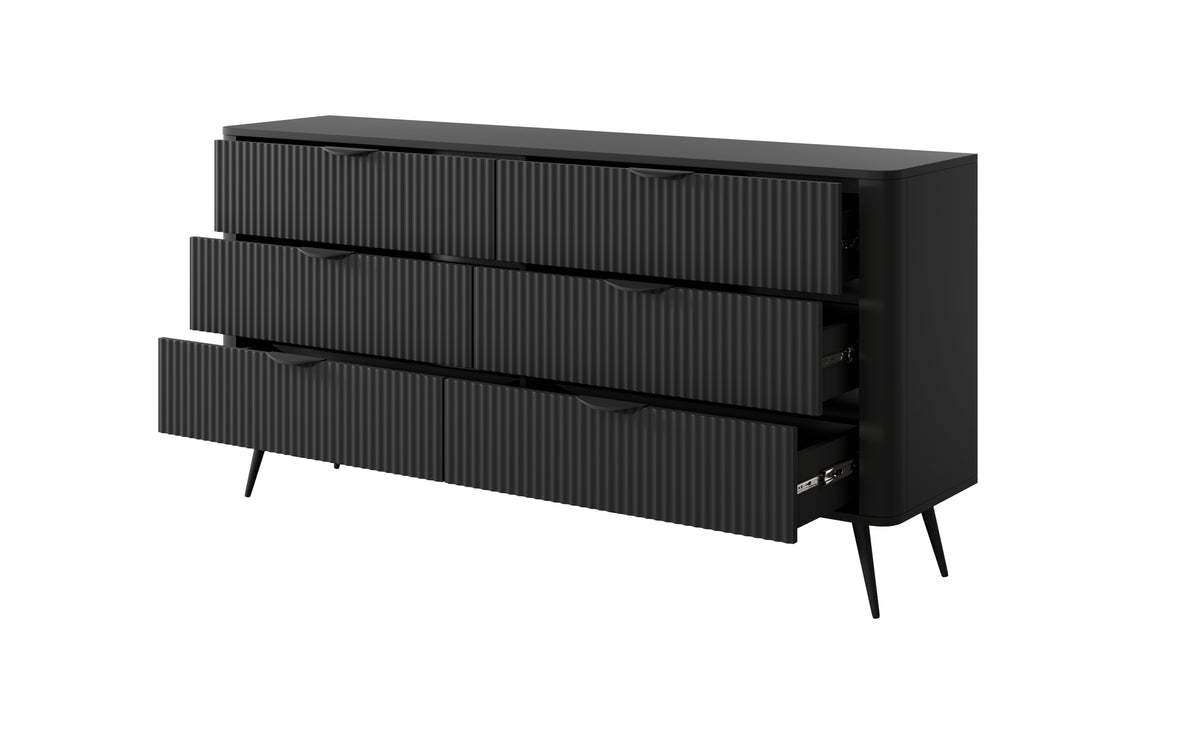 Black chest of drawers with vertical ribbed fronts, open drawer and gold bar handle details