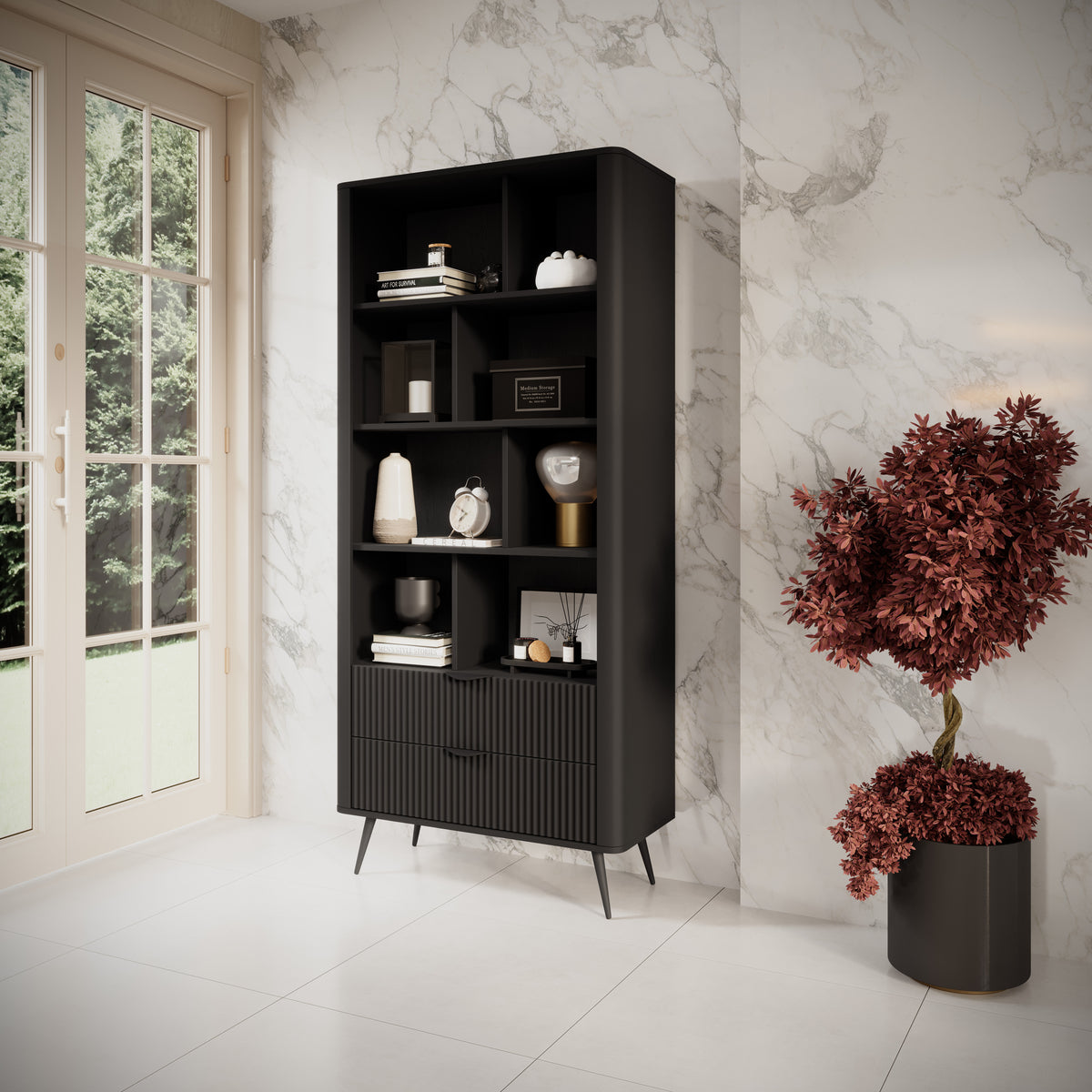 Black bookcase with open shelves and ribbed doors, styled in a living room