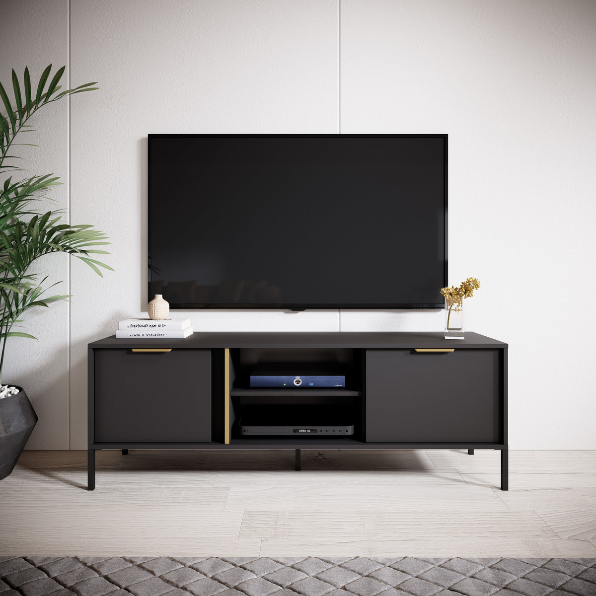 Dark TV cabinet with two doors and central shelf holding media devices, gold accents