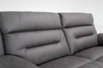 Close-up of dark gray recliner sofa upholstery with stitched cushions