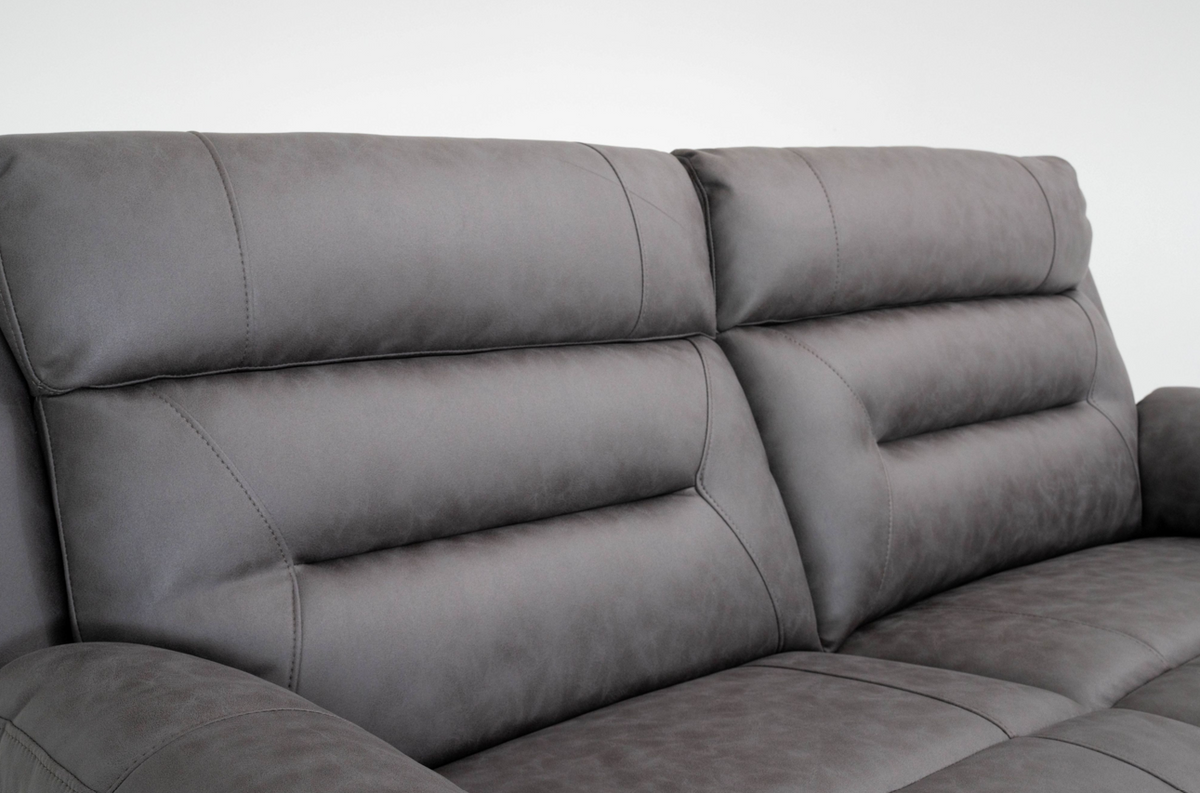 Close-up of dark gray recliner sofa upholstery with stitched cushions