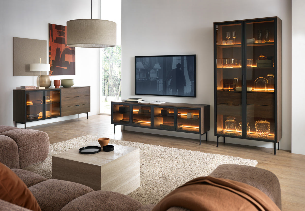 Dark TV cabinet with warm LED-lit glass doors and open storage center.