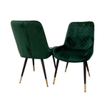 Set of two green velvet dining chairs with diamond-tufted backs and tapered legs.