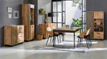 Rectangular dining table with medium-brown wood top and black metal legs in dining setting
