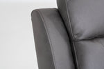 Dark gray sofa armrest with stitched edge and cushioned back panel