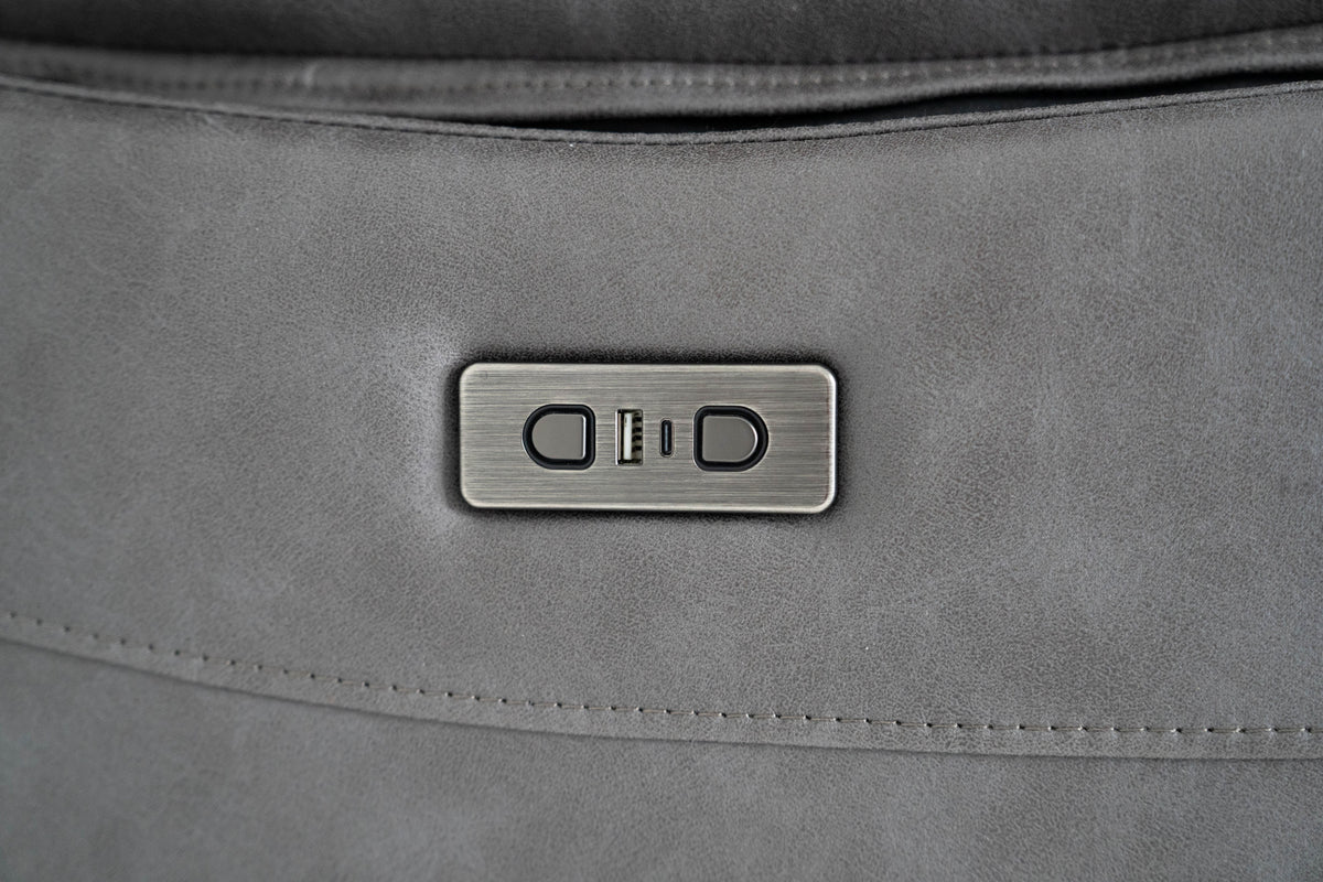 Dark gray recliner control panel with buttons on the sofa arm