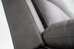 Dark gray sofa arm and cushion edge with contrast stitching details