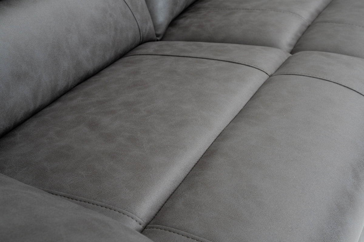 Grey recliner sofa seat cushions with padded backrest and stitched seam lines