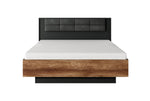 Upholstered king ottoman storage bed with dark gray headboard and wood base, closed