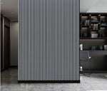 Acoustic wall panel with vertical black slats on metallic light grey backing