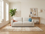 3-seater beige sofa with rounded arms and blue decorative pillow on seat