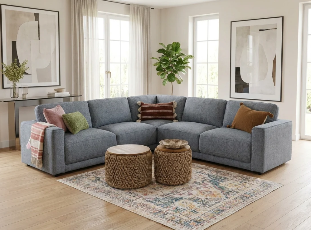 Large corner sofa, grey fabric upholstery with chaise section and decorative throw pillows