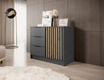 Graphite chest of drawers with three drawers and vertical gold-toned slat door panel