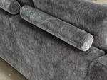 Dark gray sofa cushion and channel arm detail, textured upholstery
