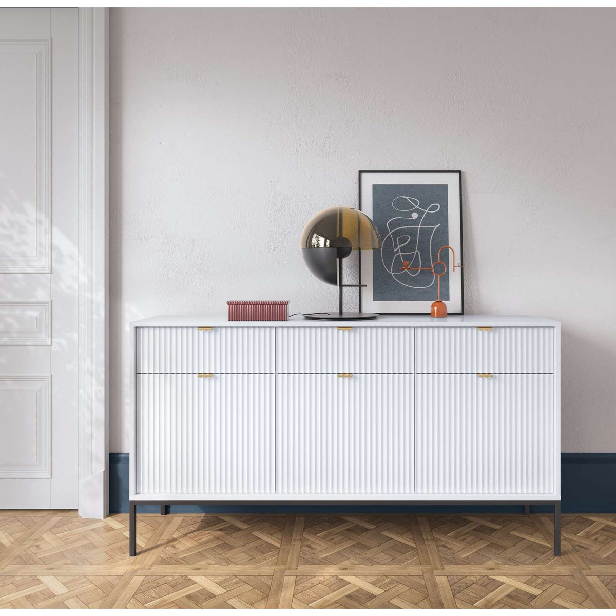 White ribbed sideboard with gold bar handles, black legs, three-door front