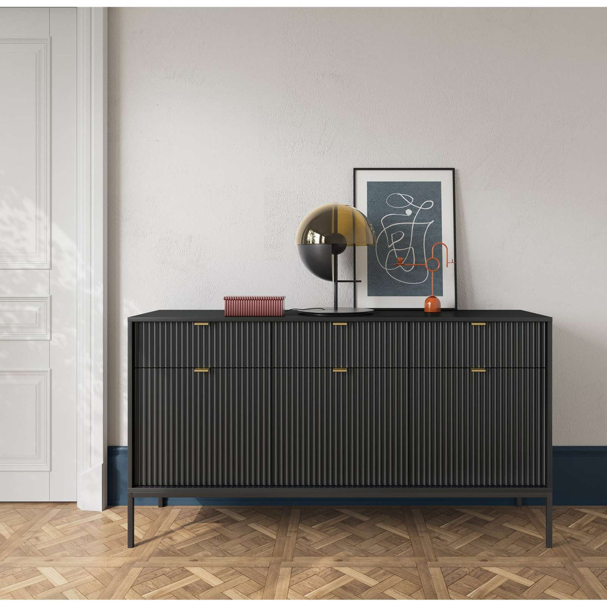 Dark gray ribbed sideboard with gold bar handles and three doors, on black legs