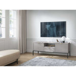 Light grey TV cabinet with ribbed drawer doors and open shelf center