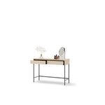 Light wood dressing table with ribbed drawer and tabletop accessories, round mirror