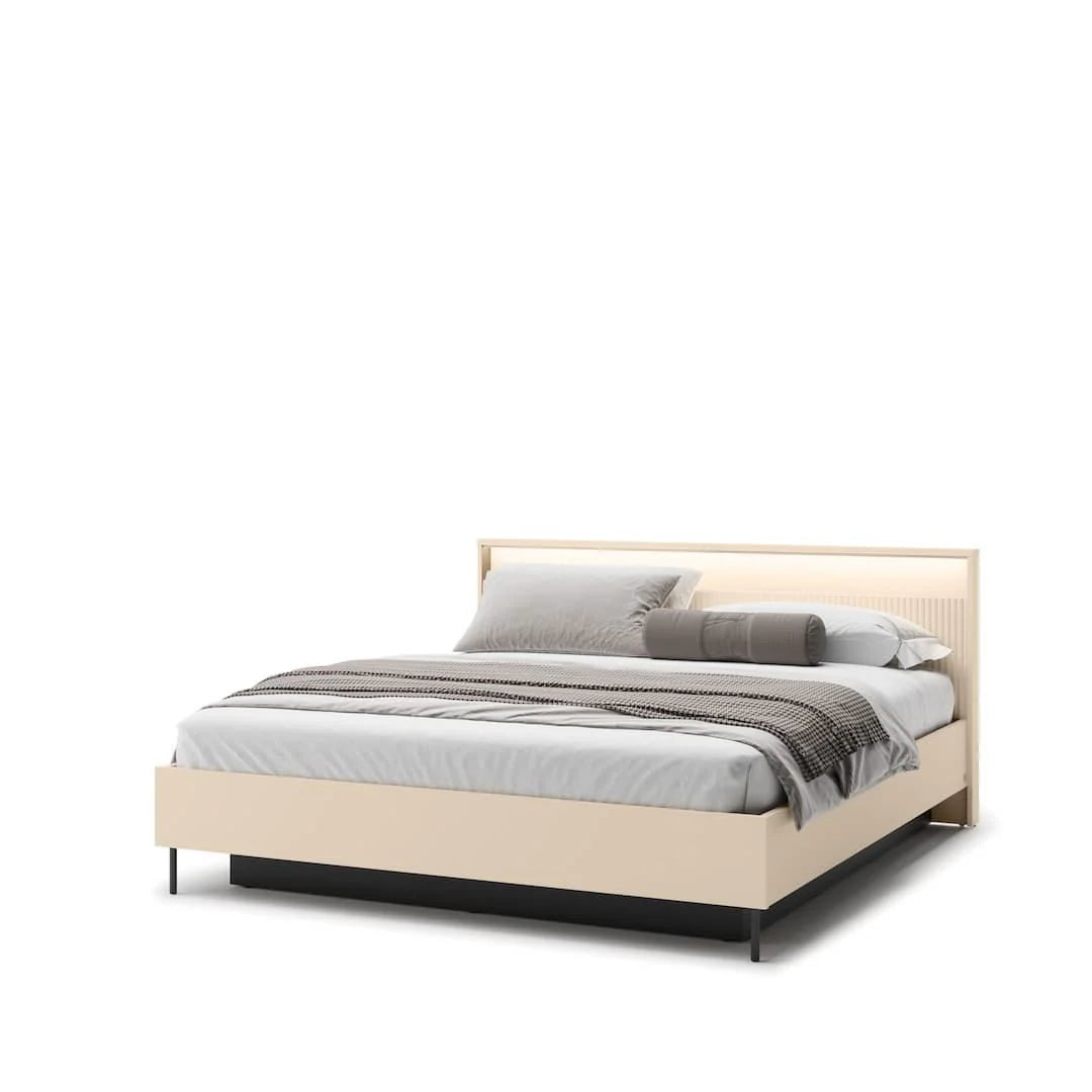 Beige upholstered ottoman bed with headboard and gray bedding set with pillows