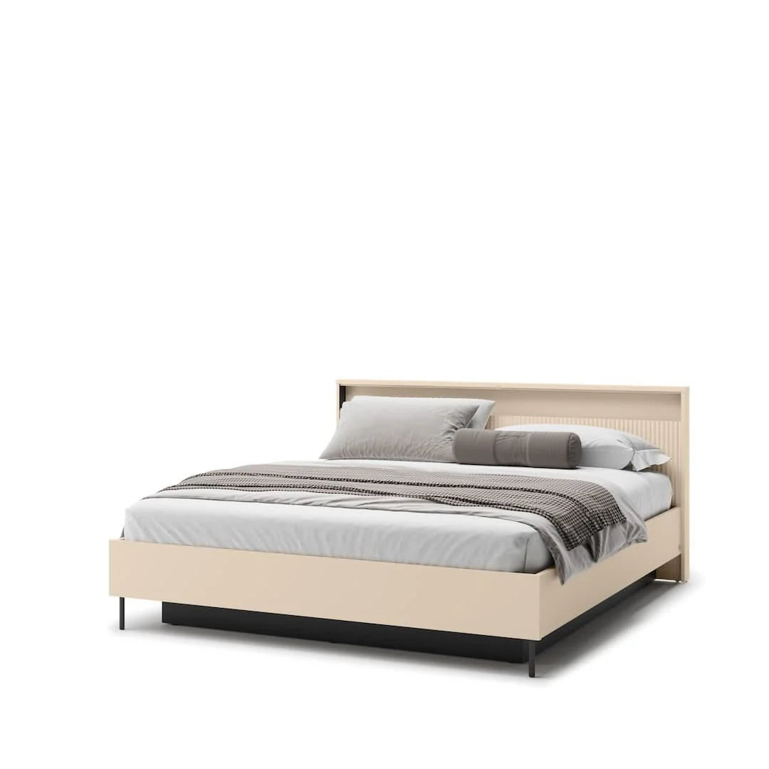 Beige upholstered ottoman bed with headboard and gray striped bedding and pillows