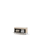 Light beige hallway bench with open storage holding folded blanket and books
