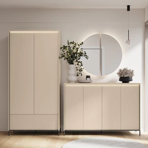 Double-door hallway cabinet with light finish and ribbed base panel in an entryway