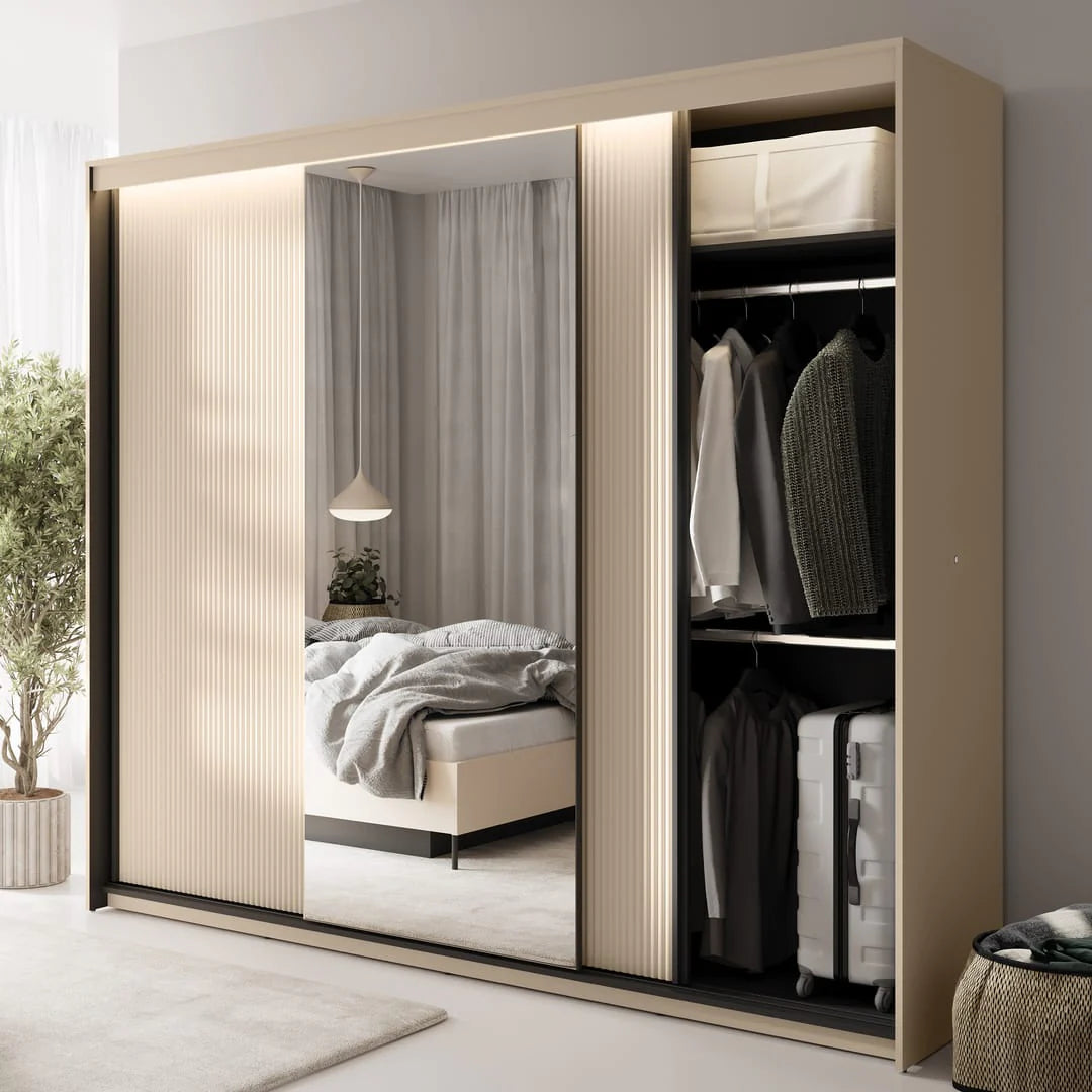Triple sliding door wardrobe partially open, showing hanging clothes and storage shelves