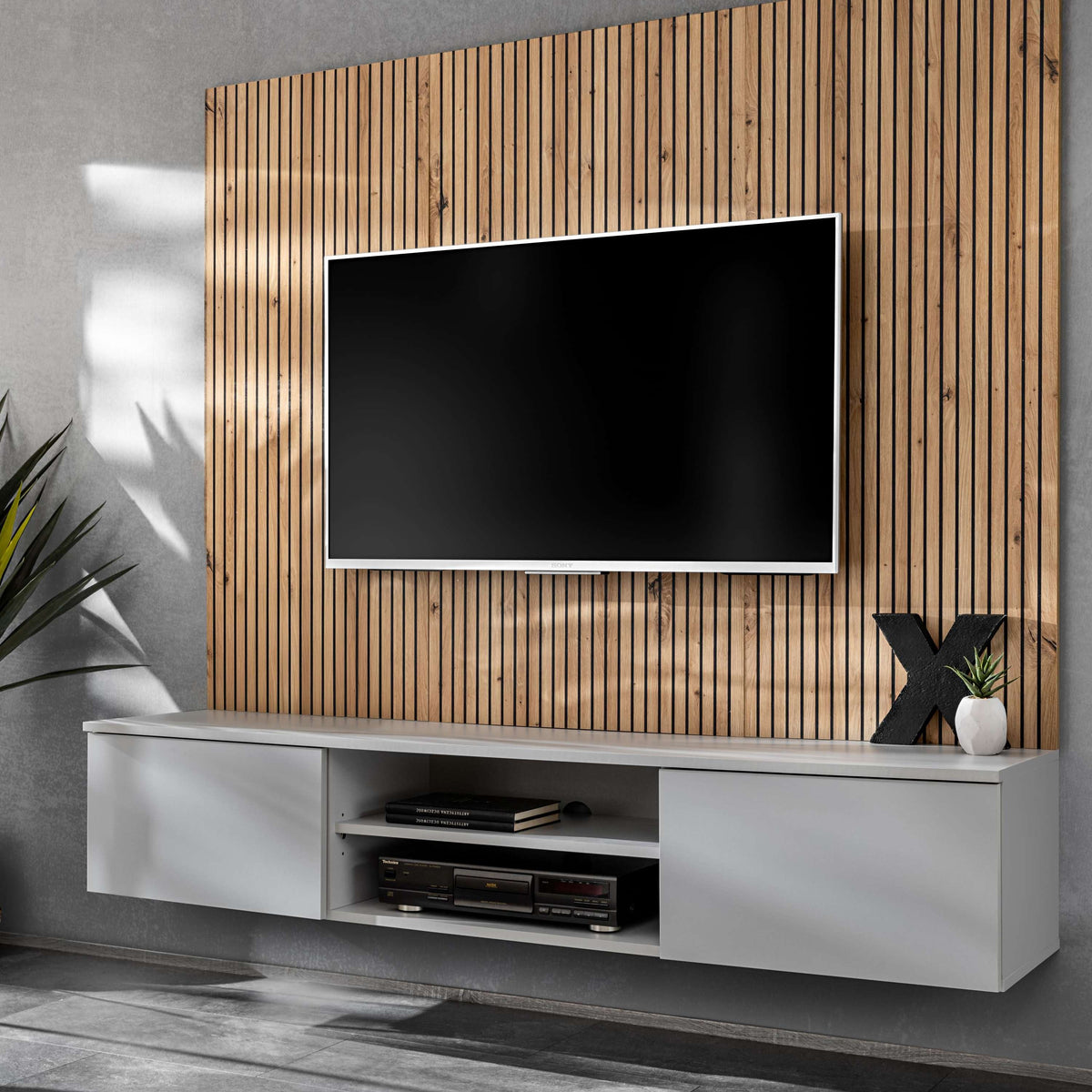 Media wall unit with mounted TV, white base, and vertical wood slat backdrop