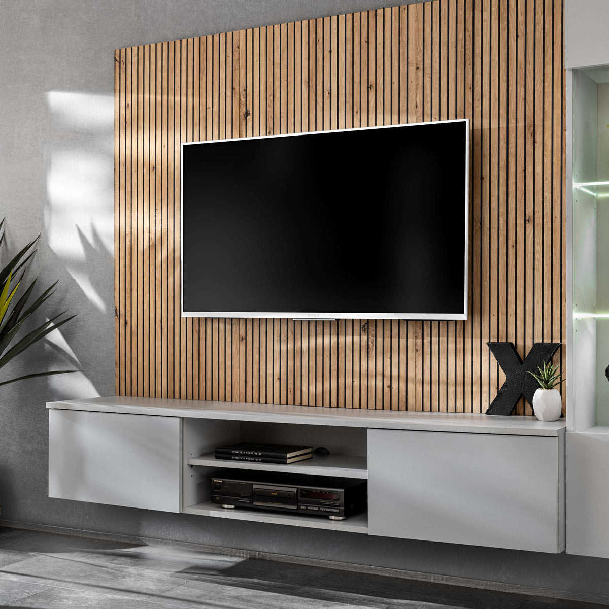 Media wall with wood slat back, gray TV console, and LED-lit glass side cabinet