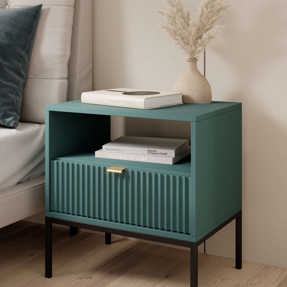 Green bedside table in a living room setting, with ribbed drawer and open shelf.