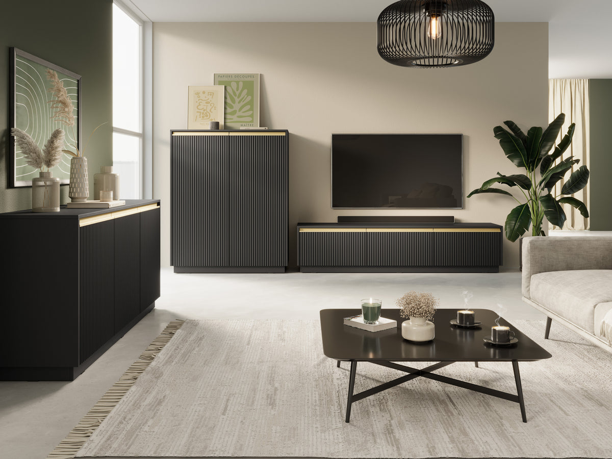 Black bedside cabinet with ribbed door and gold accent strip, coordinating media console nearby.