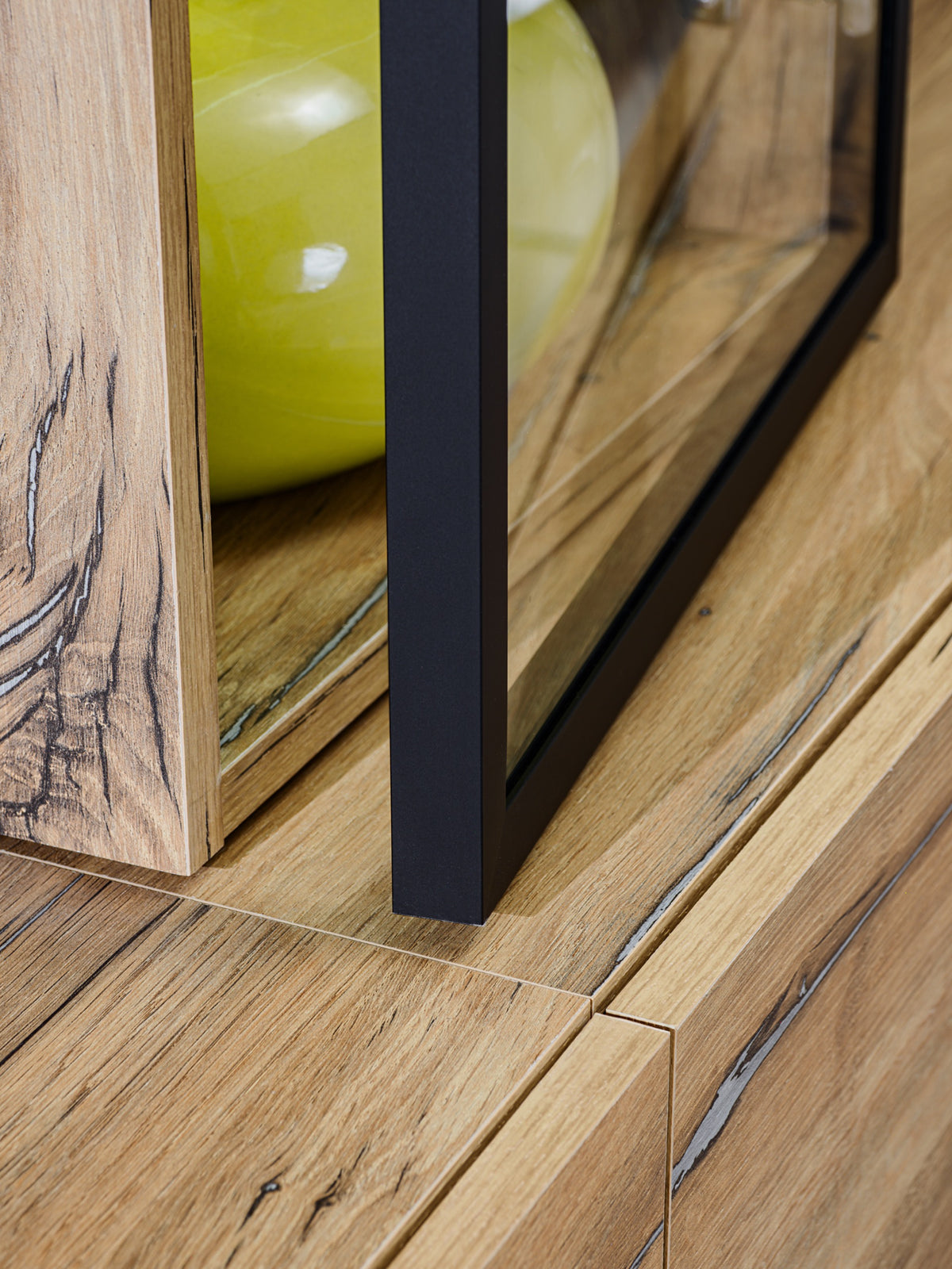 Ray TV wall unit close-up of black frame edging and oak-style shelving compartments