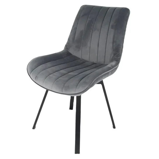 Grey velvet upholstered chair with stitched seat channels, curved back, and black legs