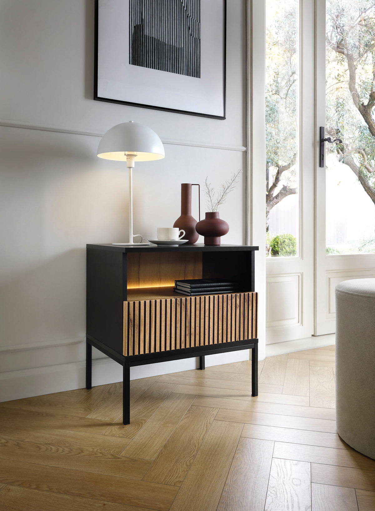 Black and oak bedside table with open shelf and ribbed vertical drawer fronts